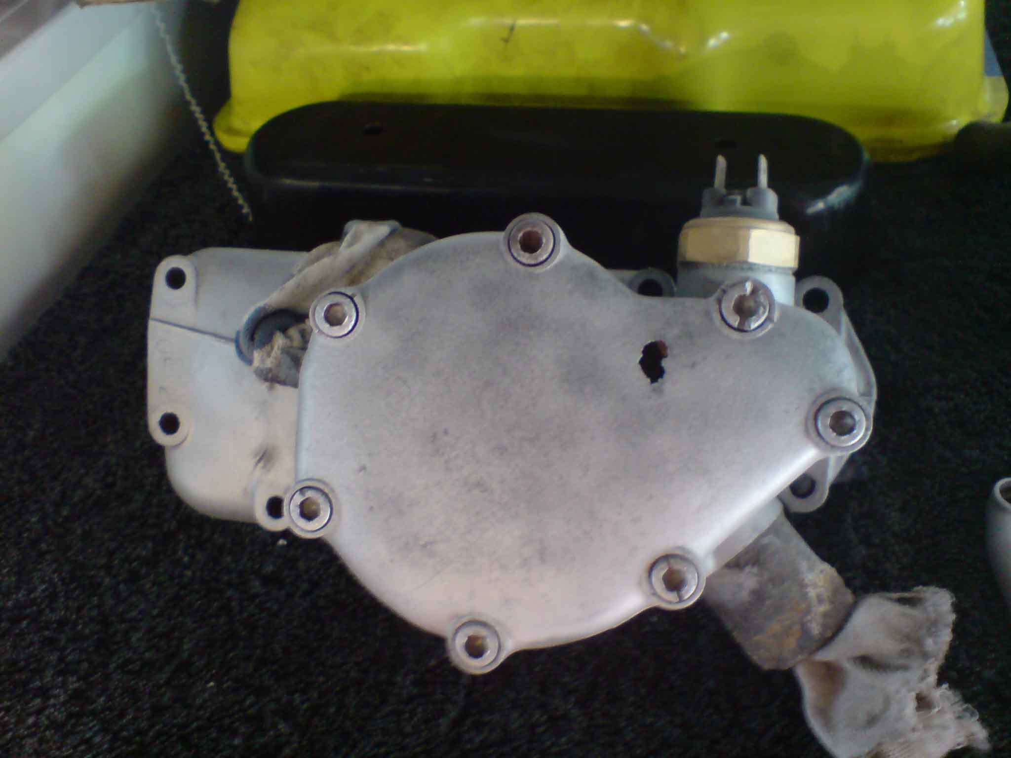 hole in water pump cover.jpg