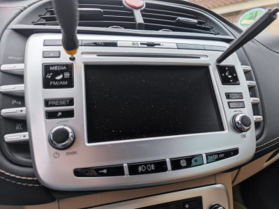 Insert two small screw drivers next to the CD player